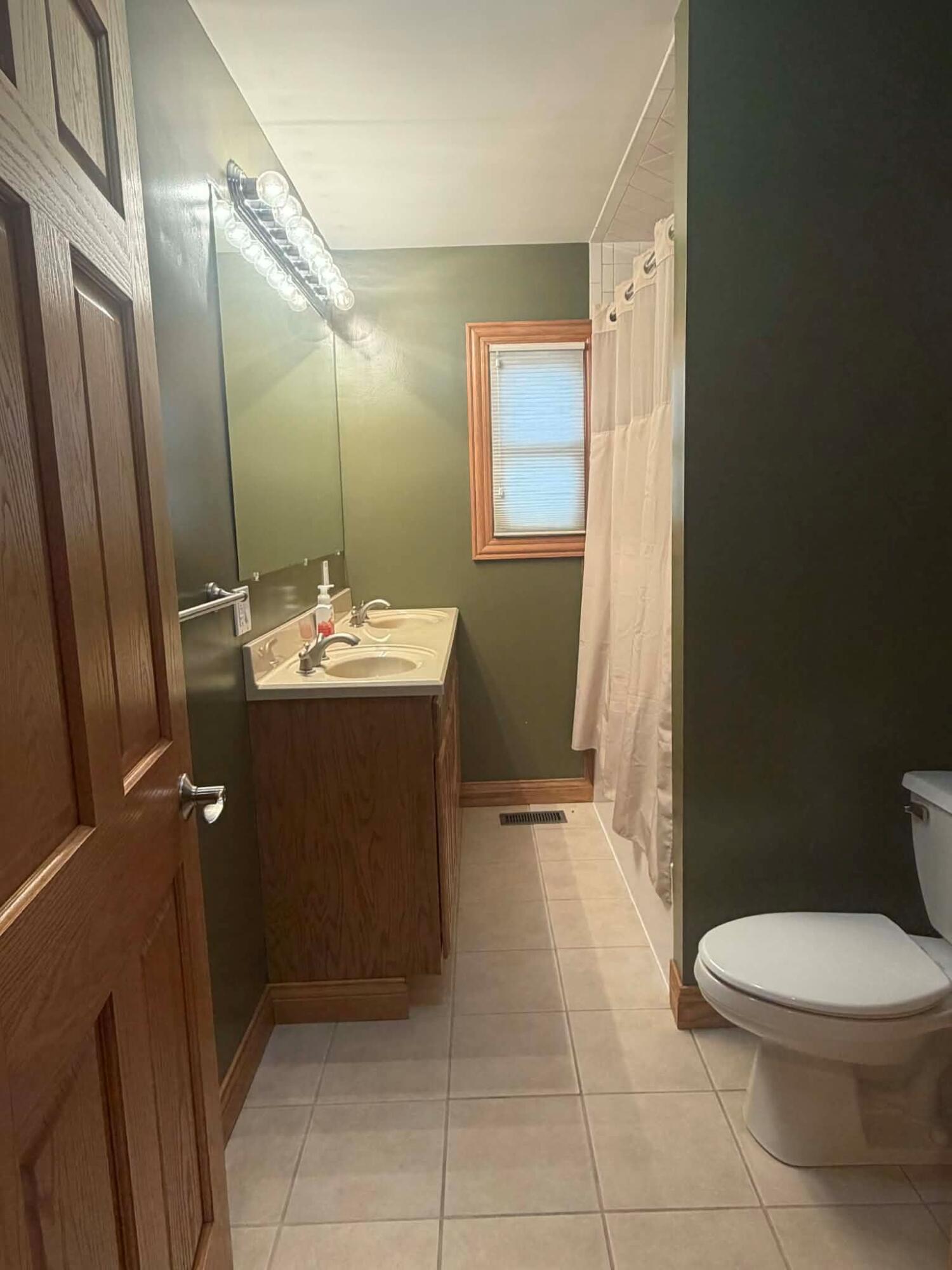 1245 West Mt Calvary Road Rensselaer, IN 47978 - Photo 23 of 35 a bathroom with a sink a toilet and mirror