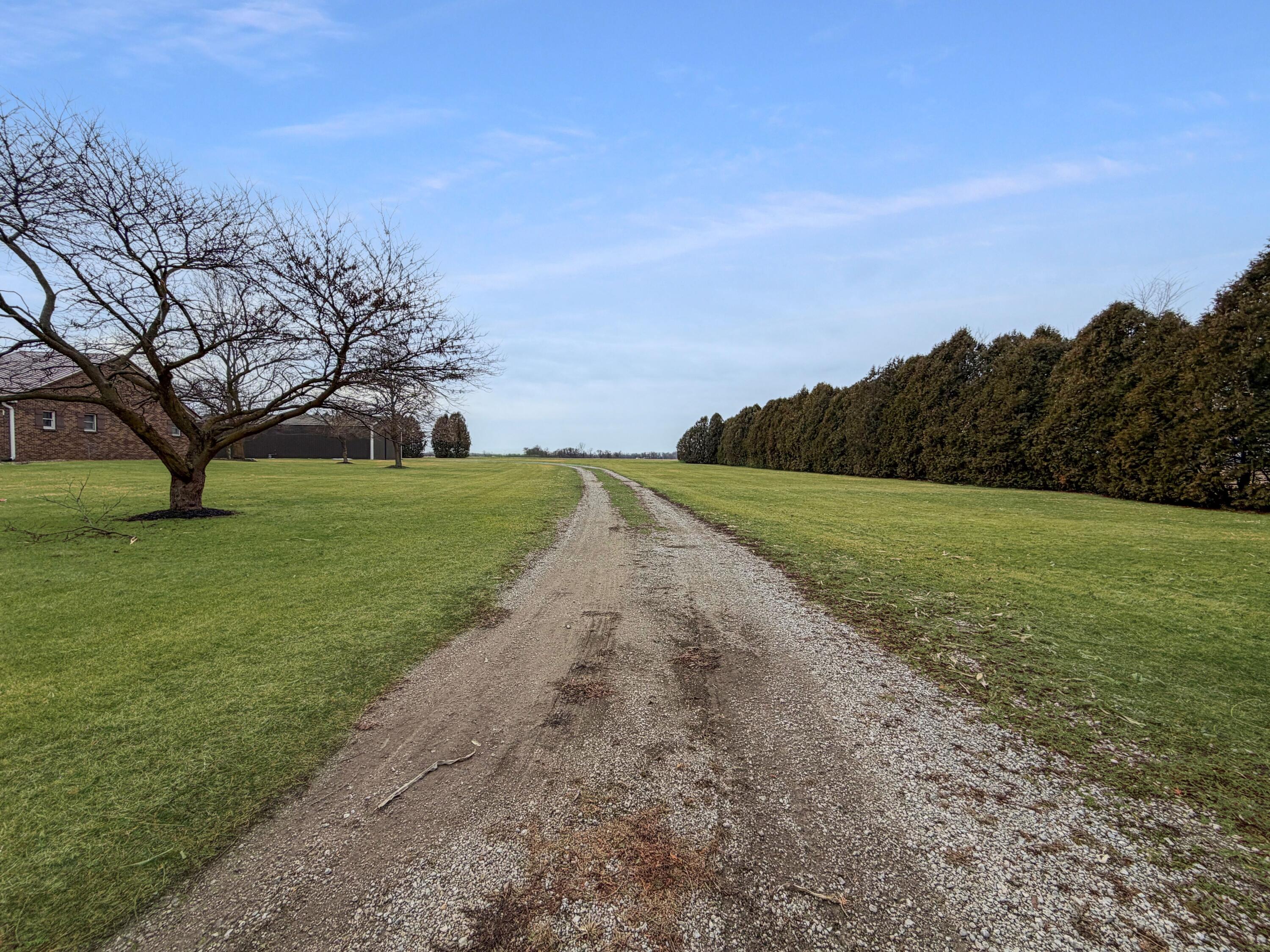 1245 West Mt Calvary Road Rensselaer, IN 47978 - Photo 6 of 35 a view of a field with an trees in the background