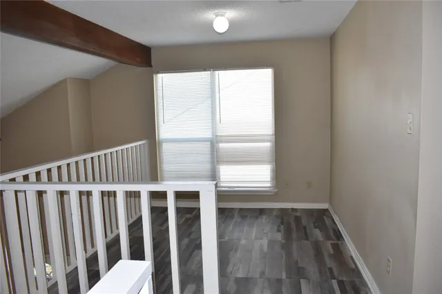 a view of a porch with wooden floor and a window