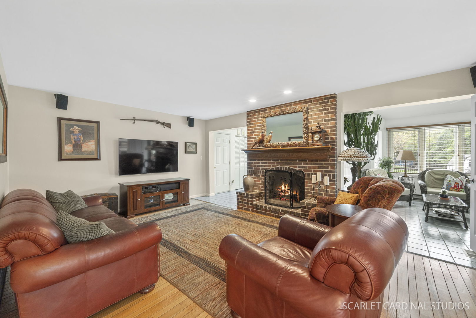 188 Hamilton Lane Wheaton, IL 60189 - Photo 7 of 34 a living room with furniture a flat screen tv and a fireplace