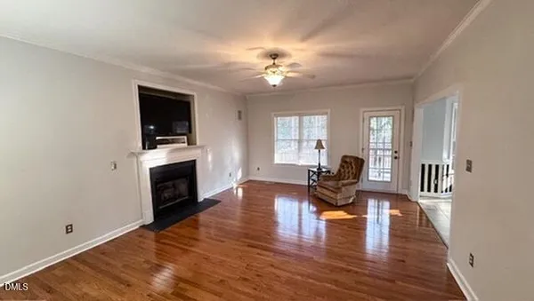 a living room with fireplace furniture and a wooden floor