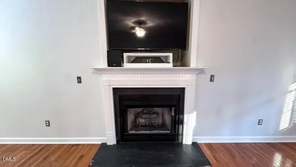 a living room with a fireplace and a flat screen tv