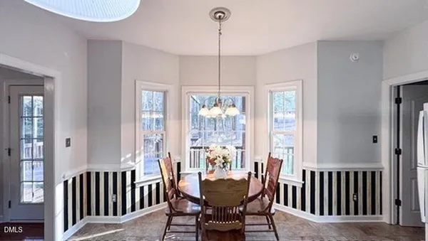 a spacious bedroom with a bed and a chandelier