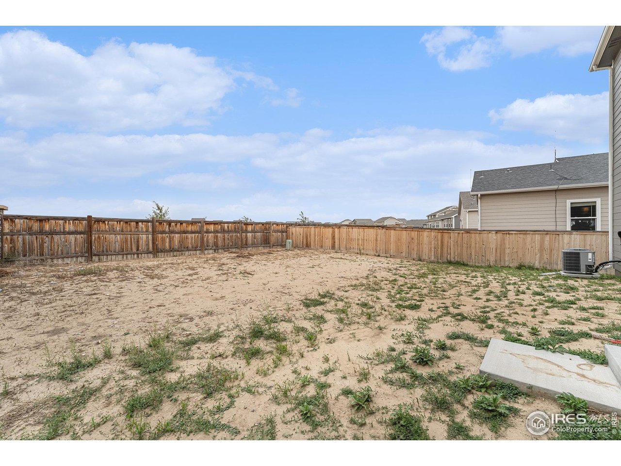 971 Ouzel Falls Road Severance, CO 80550 - Photo 14 of 16 a view of a dry yard with wooden fence