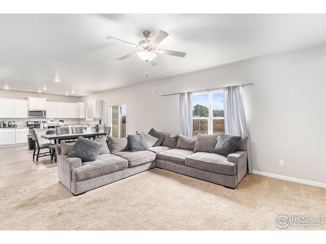 971 Ouzel Falls Road Severance, CO 80550 - Photo 16 of 16 a living room with furniture and kitchen view