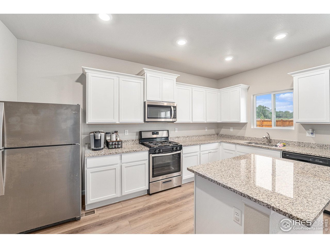 971 Ouzel Falls Road Severance, CO 80550 - Photo 4 of 16 a kitchen with a sink stove and refrigerator