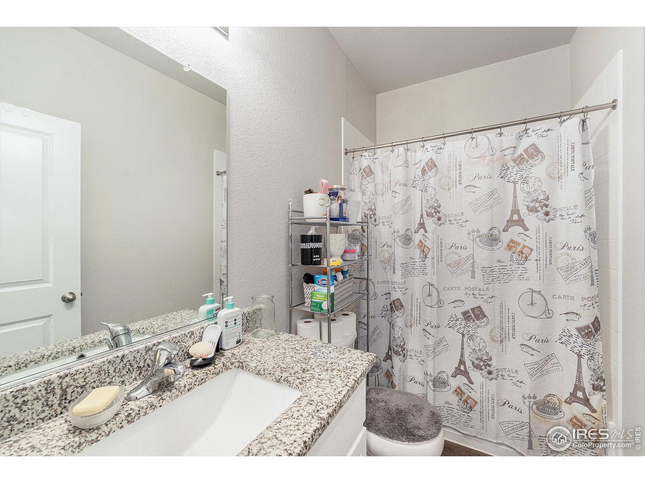 971 Ouzel Falls Road Severance, CO 80550 - Photo 6 of 16 a bathroom with a granite countertop sink a mirror and shower