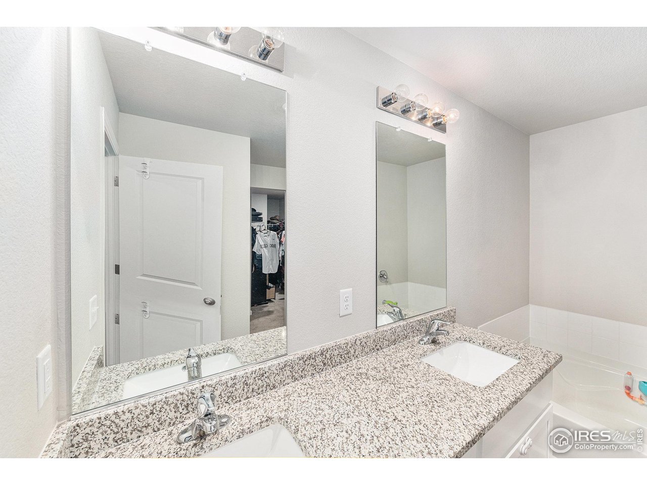 971 Ouzel Falls Road Severance, CO 80550 - Photo 8 of 16 a bathroom with a granite countertop sink and a mirror