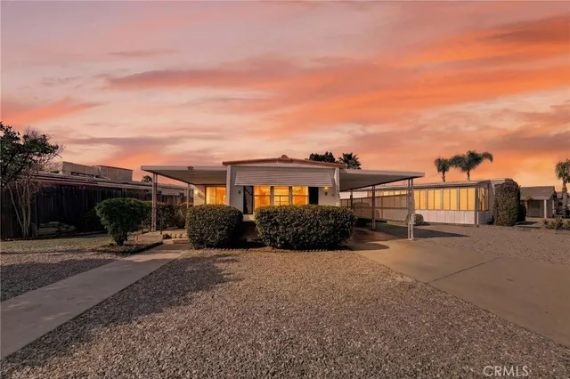 a view of a house with backyard and sitting area