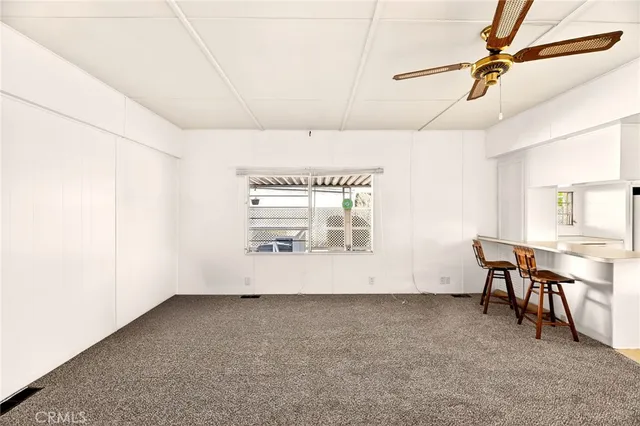 a view of a hallway with wooden cabinets and entryway
