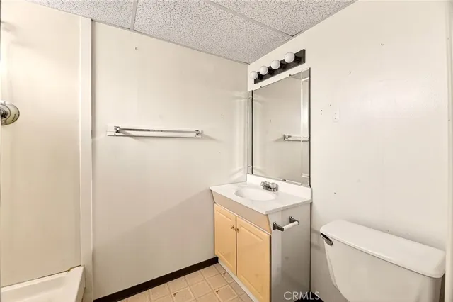 a spacious bathroom with a granite countertop sink mirror and a