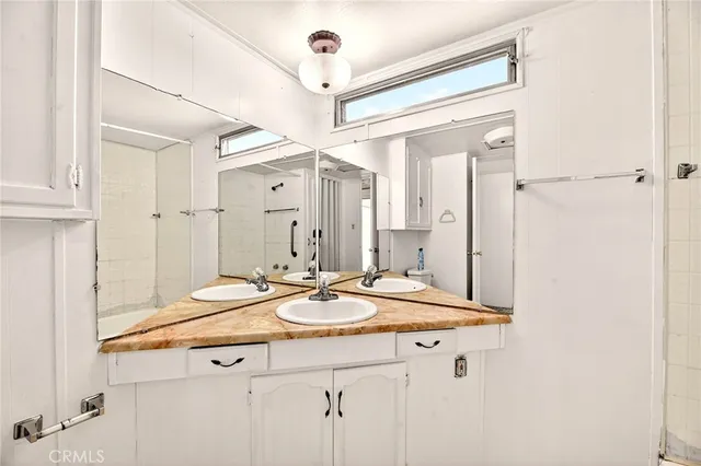 a bedroom with a bed and glass windows