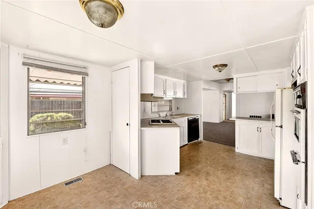 a kitchen with stainless steel appliances kitchen island granite countertop a refrigerator and a stove