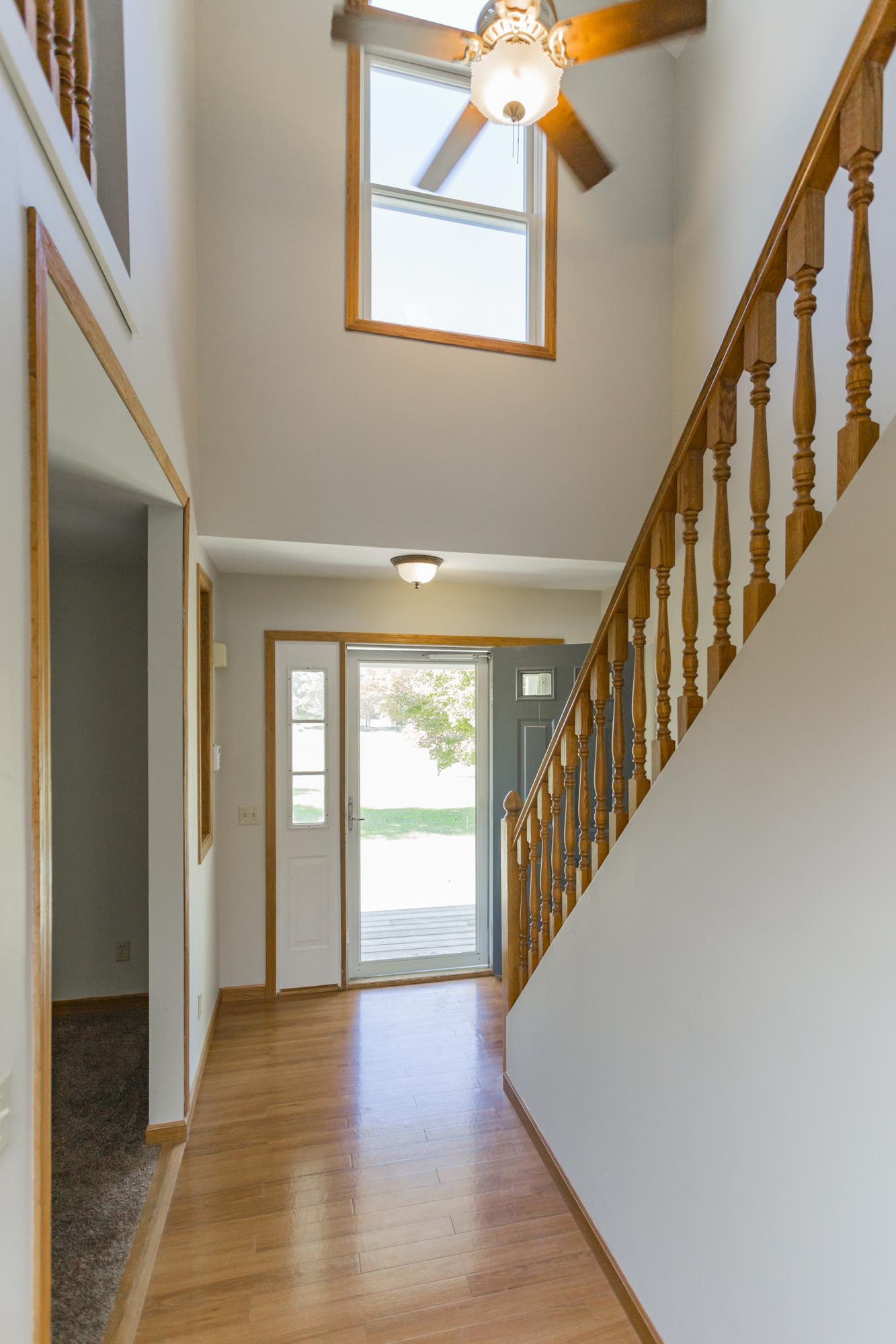 Inviting foyer boasting natural light through the large 2nd story window.