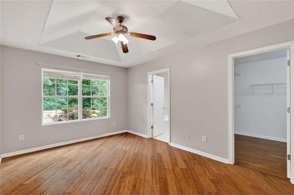 466 Raymond Drive Winder, GA 30680 - Photo 16 of 33 an empty room with wooden floor and windows