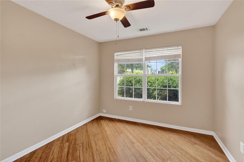 466 Raymond Drive Winder, GA 30680 - Photo 19 of 33 a view of an empty room with wooden floor and a window