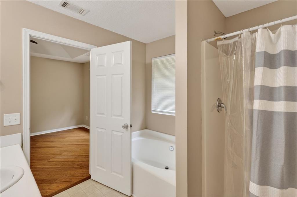 466 Raymond Drive Winder, GA 30680 - Photo 21 of 33 a bathroom with a shower and a sink