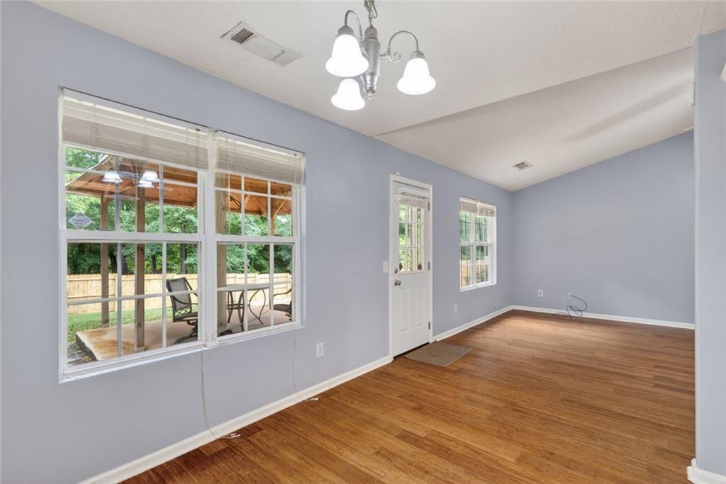 466 Raymond Drive Winder, GA 30680 - Photo 22 of 33 a view of an empty room with wooden floor and a window