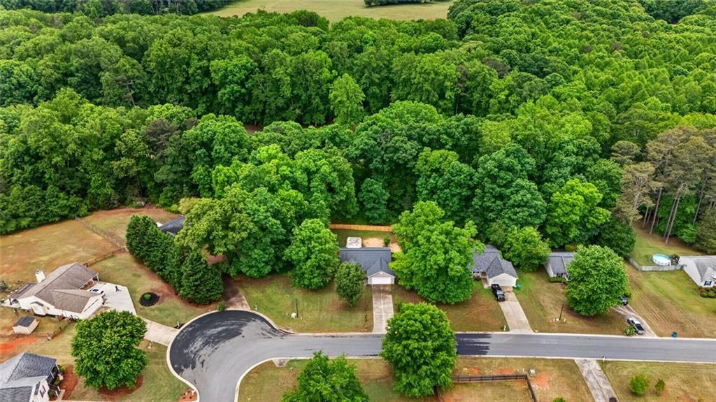 466 Raymond Drive Winder, GA 30680 - Photo 23 of 33 an aerial view of a house with swimming pool outdoor seating and yard