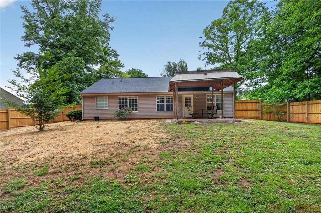 466 Raymond Drive Winder, GA 30680 - Photo 28 of 33 a front view of a house with a garden