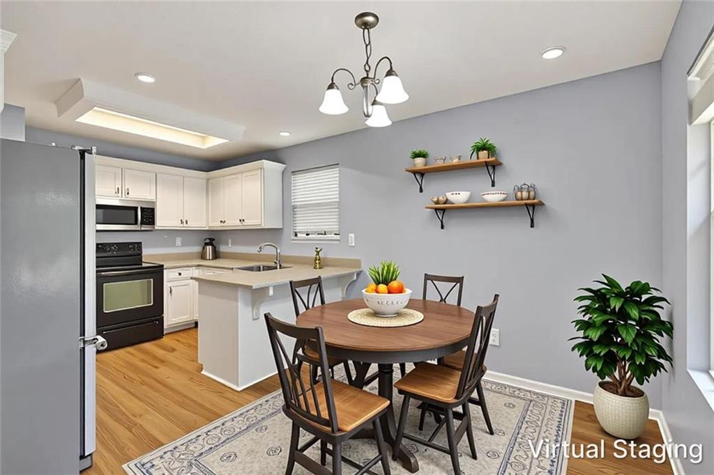 466 Raymond Drive Winder, GA 30680 - Photo 5 of 33 a kitchen with a table and chairs in it