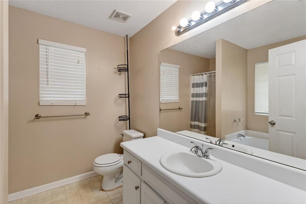 466 Raymond Drive Winder, GA 30680 - Photo 9 of 33 a bathroom with a sink a toilet and shower