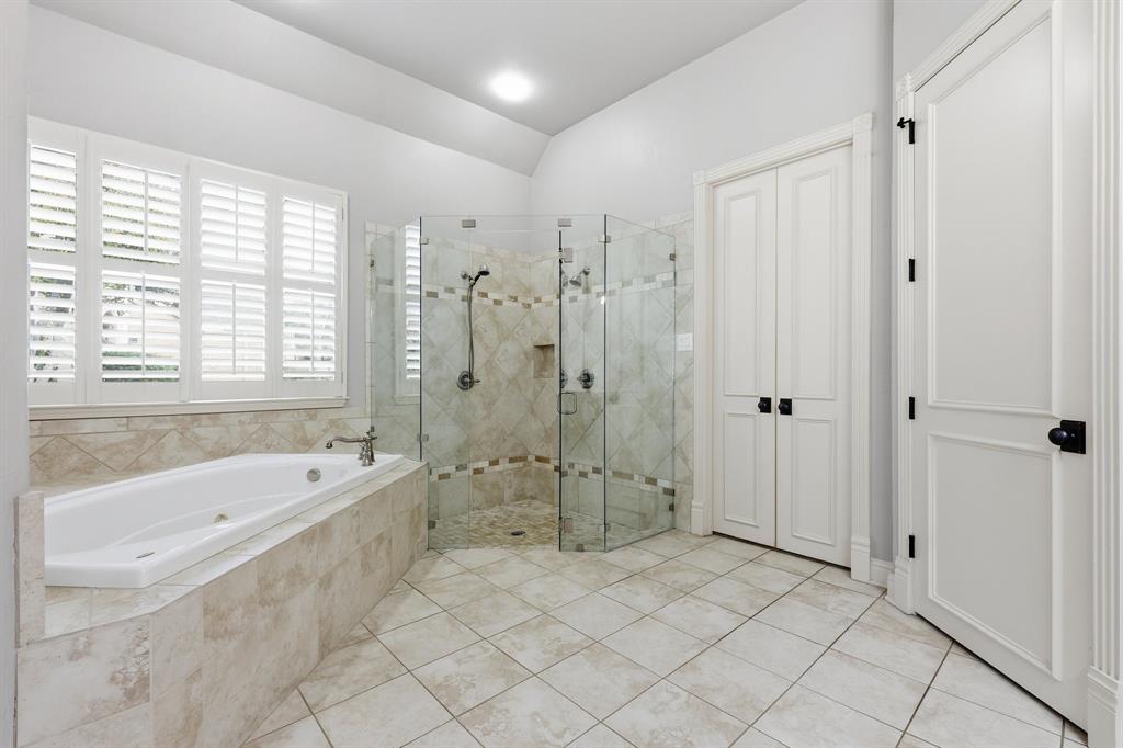 2201 Mockingbird Lane Flower Mound, TX 75022 - Photo 19 of 40 a spacious bathroom with a bathtub shower and a sink