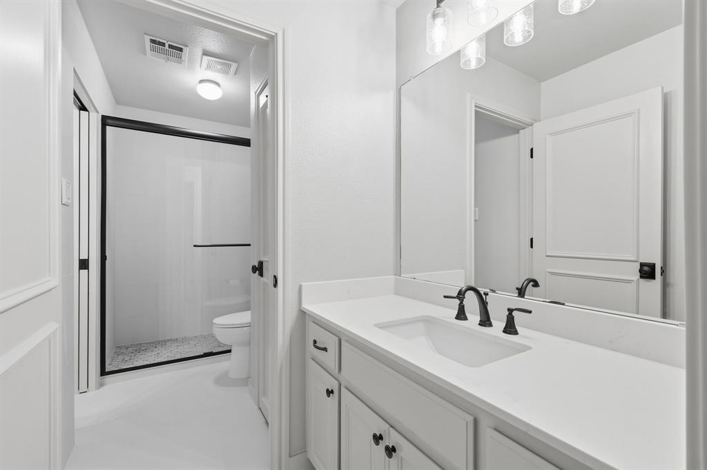2201 Mockingbird Lane Flower Mound, TX 75022 - Photo 23 of 40 a bathroom with a sink a toilet and shower