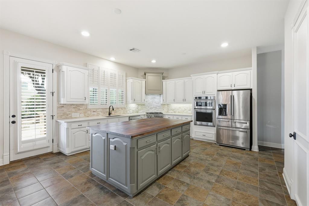 2201 Mockingbird Lane Flower Mound, TX 75022 - Photo 7 of 40 a kitchen with a sink stove and refrigerator