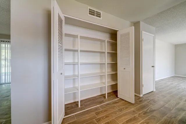 a view of an empty room with empty shelves