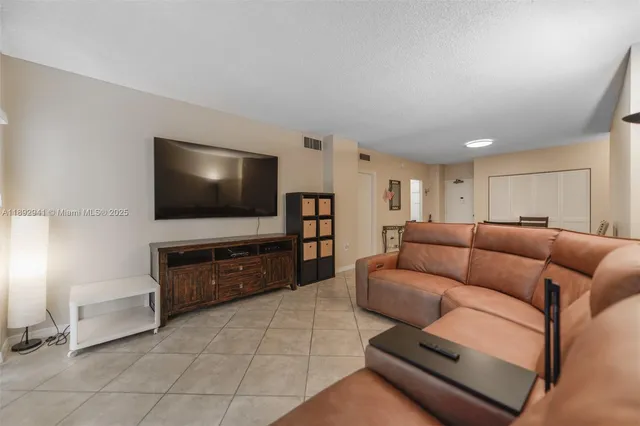 a view of a backyard with a patio and ocean view