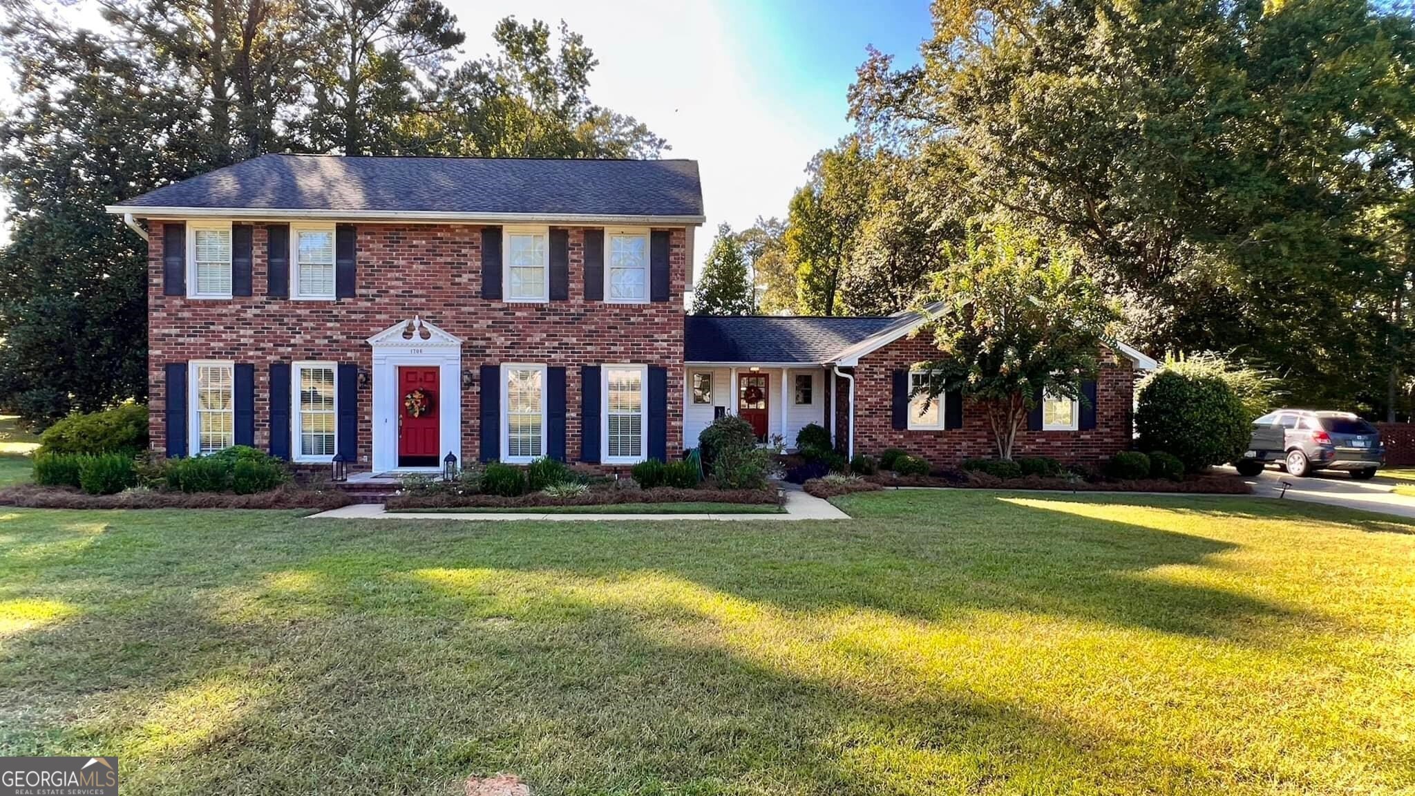 a front view of a residential apartment building with a yard