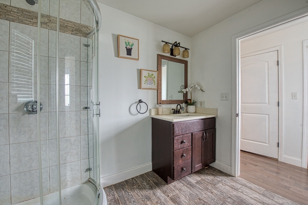 438 Smith Street Fall River, MA 02721 - Photo 16 of 31 a bathroom with a double vanity sink a mirror and shower