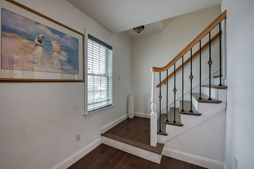 438 Smith Street Fall River, MA 02721 - Photo 17 of 31 a view of an entryway with wooden floor and stairs