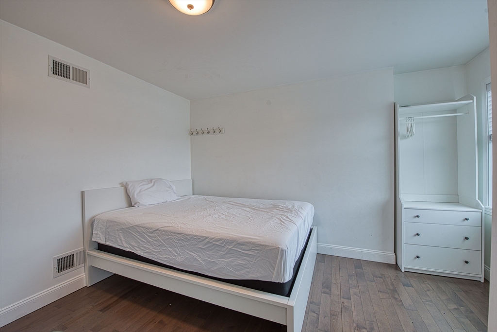 438 Smith Street Fall River, MA 02721 - Photo 26 of 31 a bedroom with a bed and wooden floor