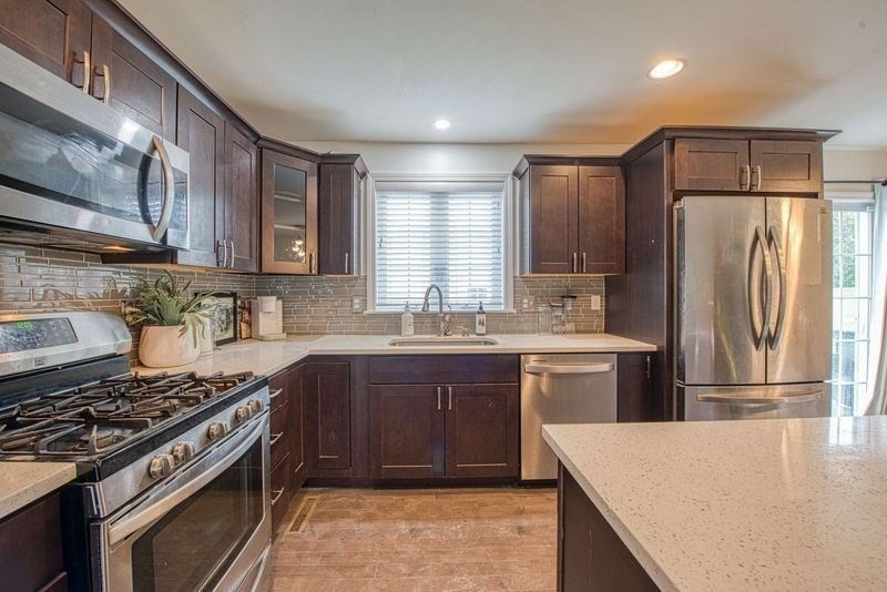 438 Smith Street Fall River, MA 02721 - Photo 5 of 31 a kitchen with stainless steel appliances granite countertop a stove a refrigerator and a sink