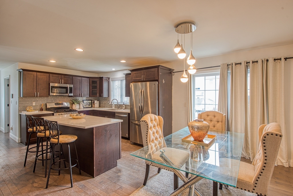 438 Smith Street Fall River, MA 02721 - Photo 8 of 31 a view of a dining room with furniture and a chandelier