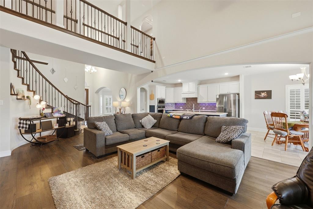 418 Crestview Drive Midlothian, TX 76065 - Photo 12 of 39 a living room with furniture a wooden floor and a chandelier