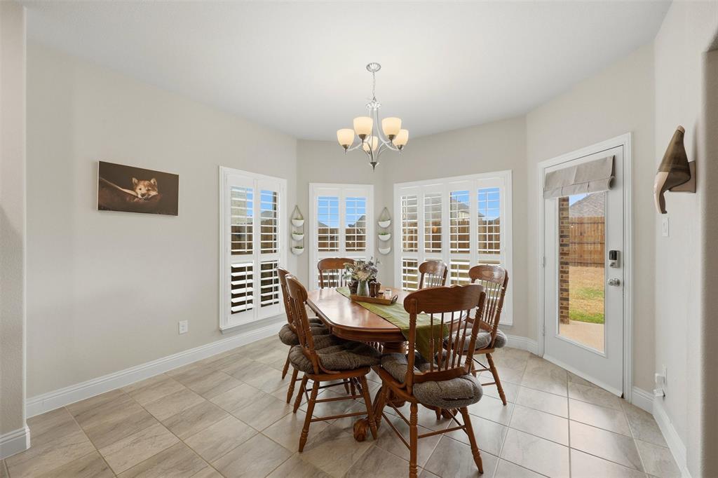418 Crestview Drive Midlothian, TX 76065 - Photo 14 of 39 a view of a dining room with furniture large windows and wooden floor