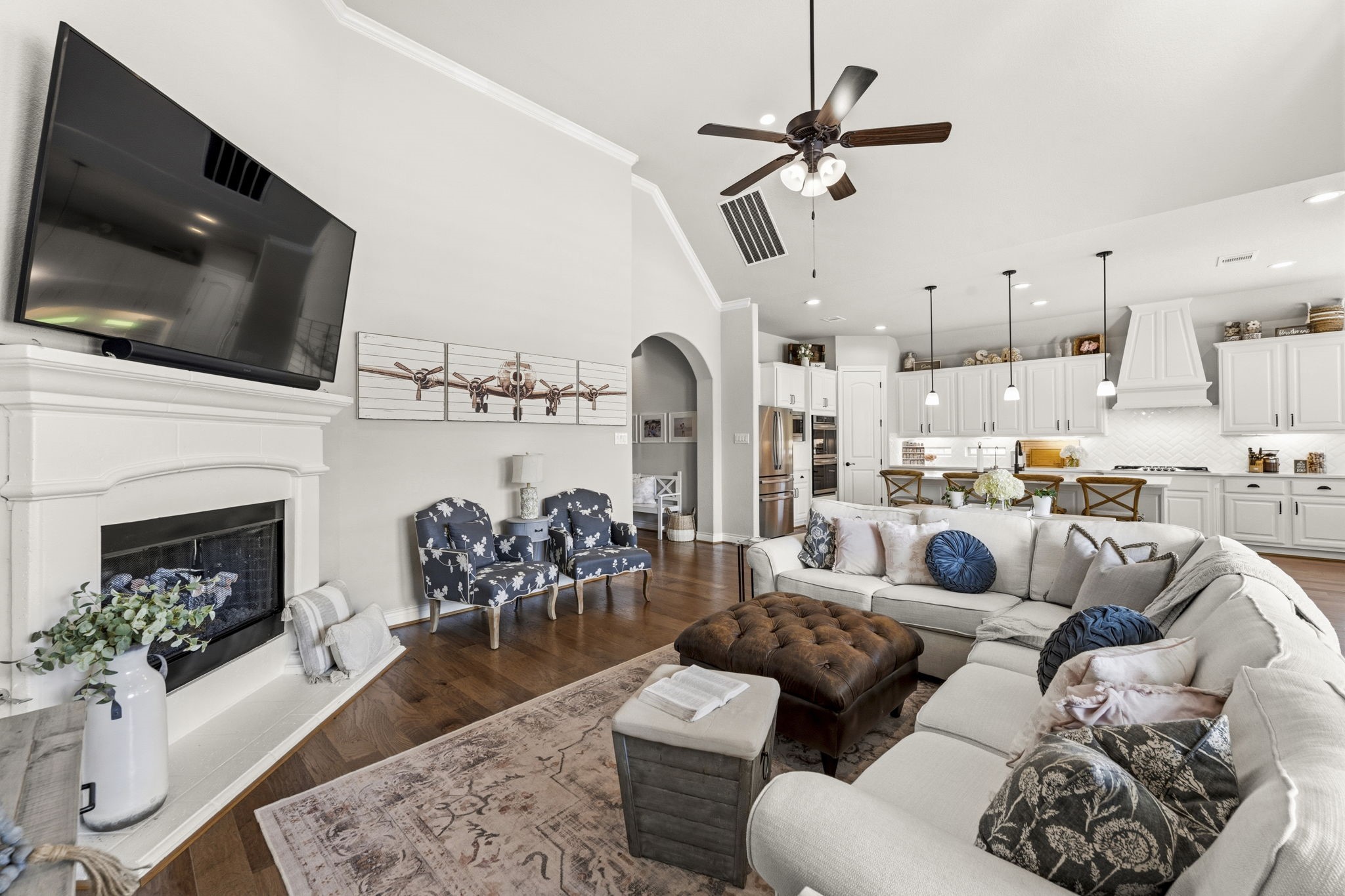 14012 Beartooth Bend Trail Conroe, TX 77384 - Photo 12 of 50 This beautifully designed Family Room blends style and function, featuring warm wood flooring, plantation shutters, crown molding, and recessed lighting. A lighted ceiling fan adds both comfort and charm. Conveniently located just off the kitchen, this open-concept space makes it easy to stay connected while entertaining or enjoying everyday moments.