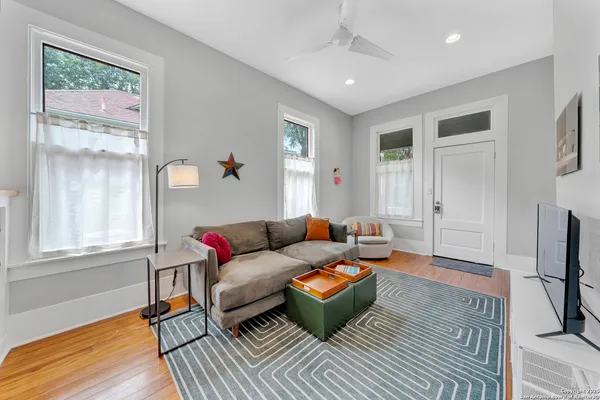 a living room with furniture fireplace and a window