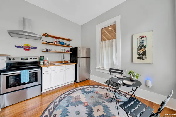 a kitchen with stainless steel appliances a stove a sink and a refrigerator