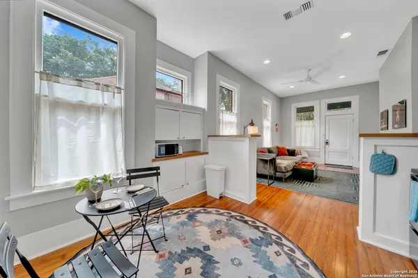 a living room with furniture a flat screen tv and a table