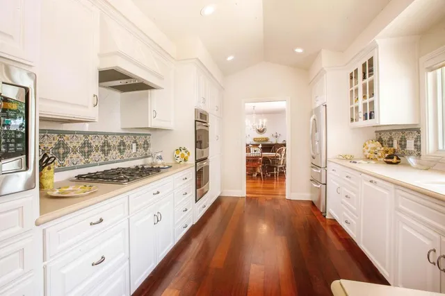 a view of a dining room with furniture wooden floor and chandelier