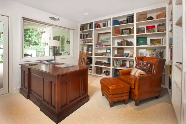 a living room with furniture wooden floor and a large window