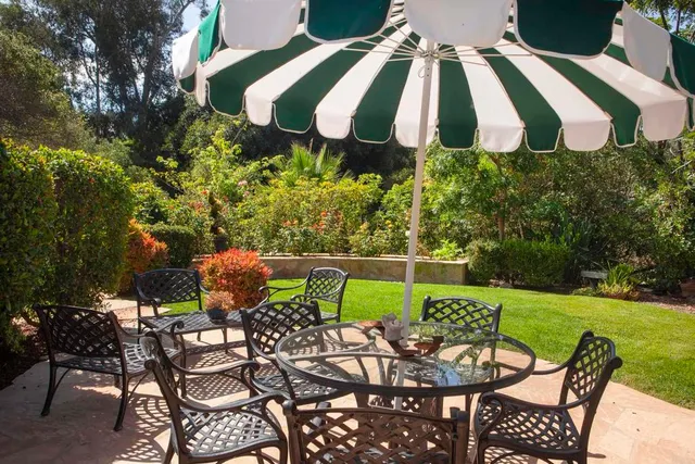 a view of a chairs and table in the patio