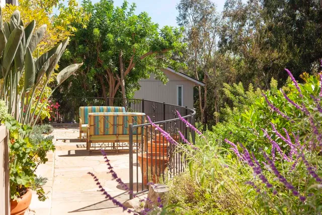a view of balcony with wooden floor and outdoor seating
