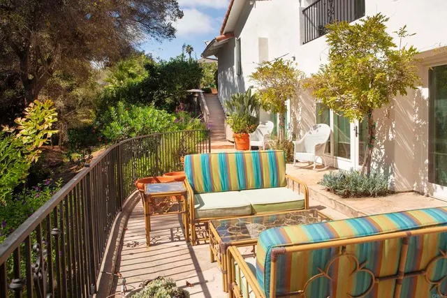 a view of a house with a tree in front of it