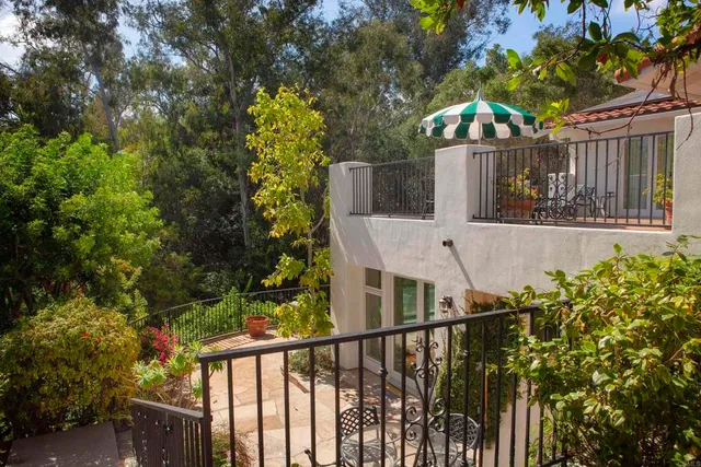 a bed sitting in a spacious bedroom next to a window