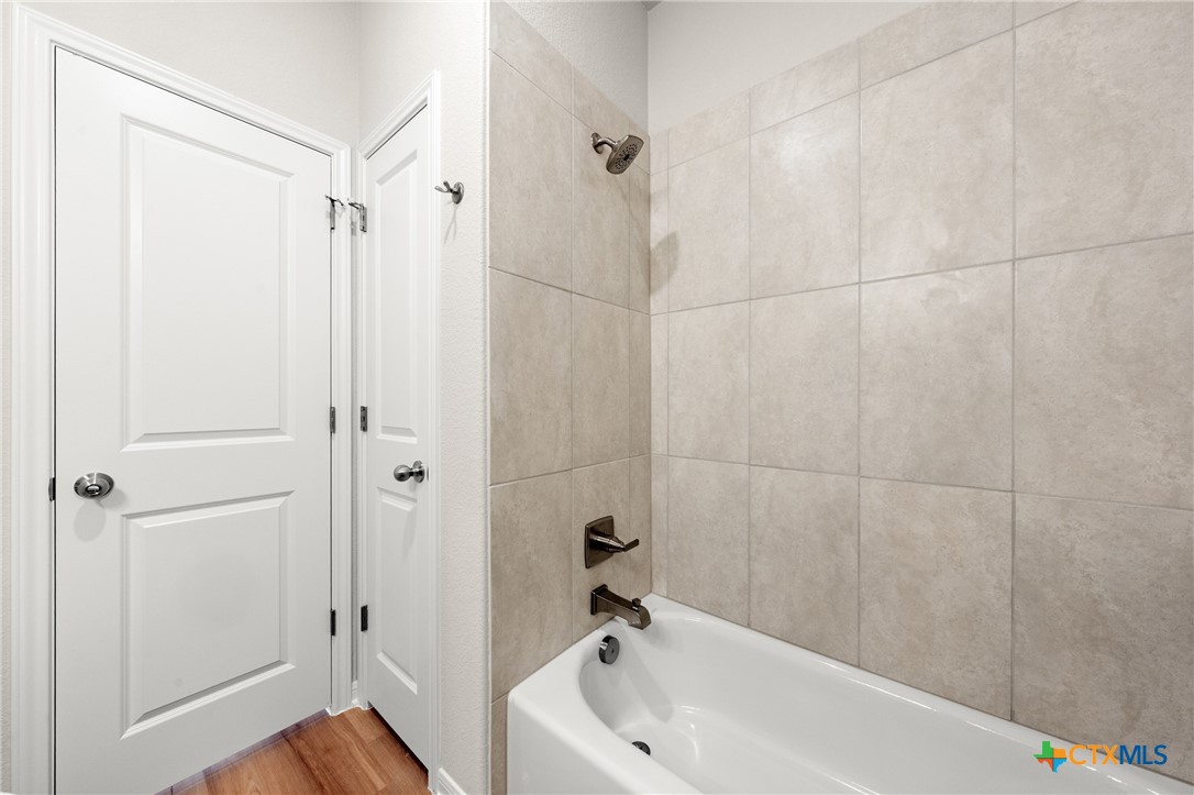 8024 Pineridge Way Temple, TX 76502 - Photo 21 of 32 a bathroom with a tub and a shower